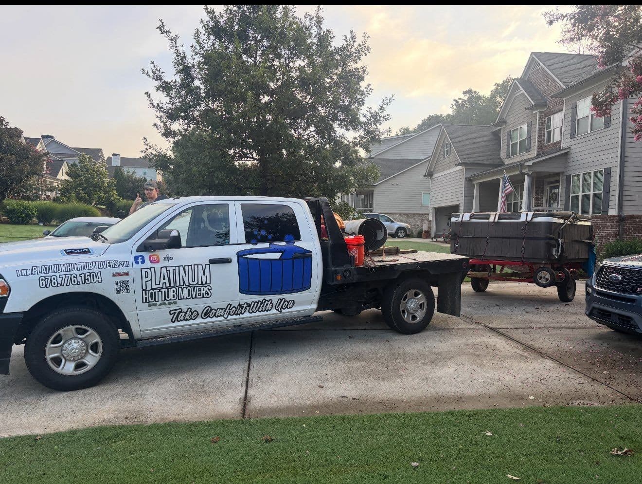 The branded Platinum Hot Tub Movers truck at golden hour